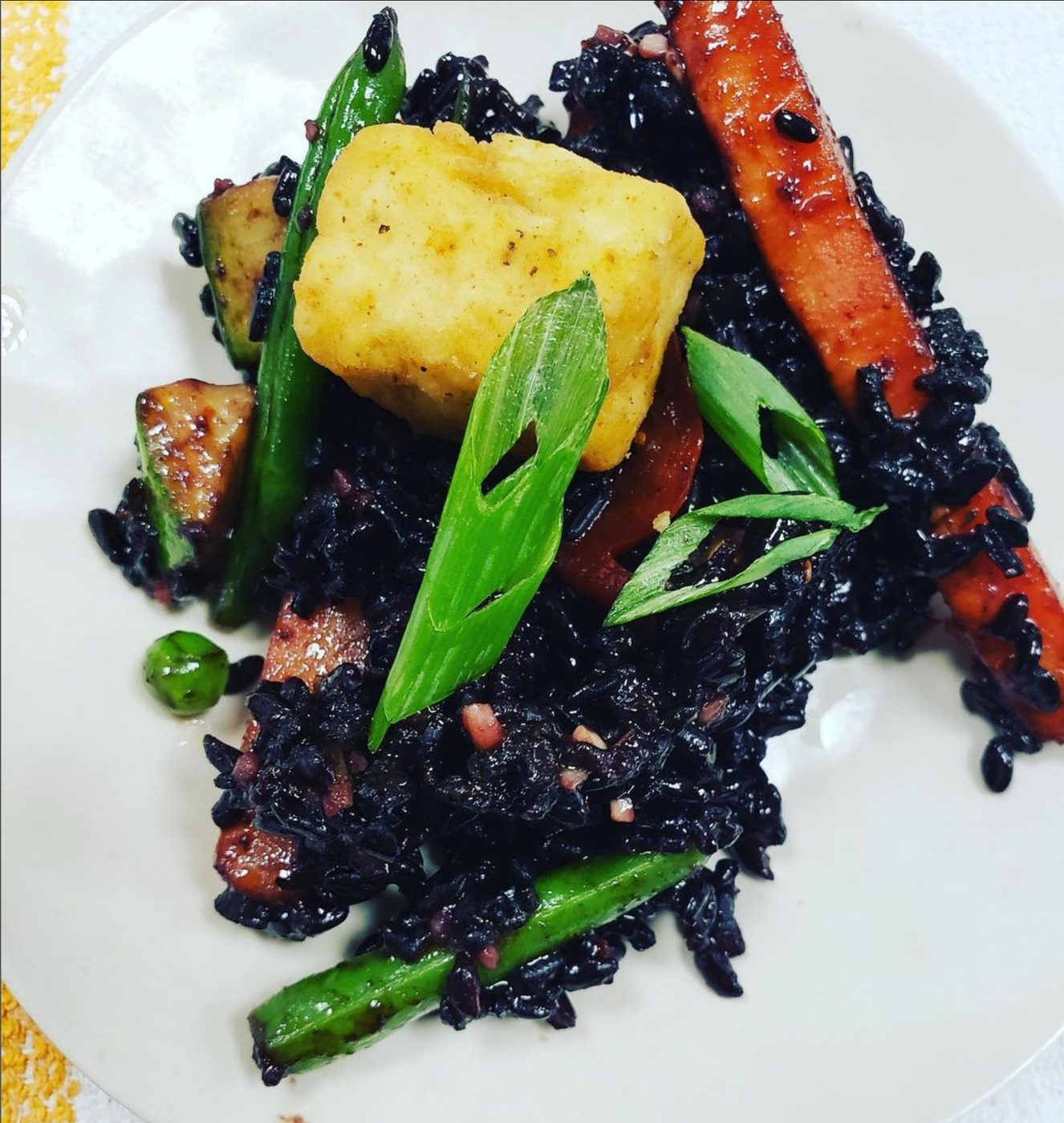 Crisp fish over black rice with roasted carrots