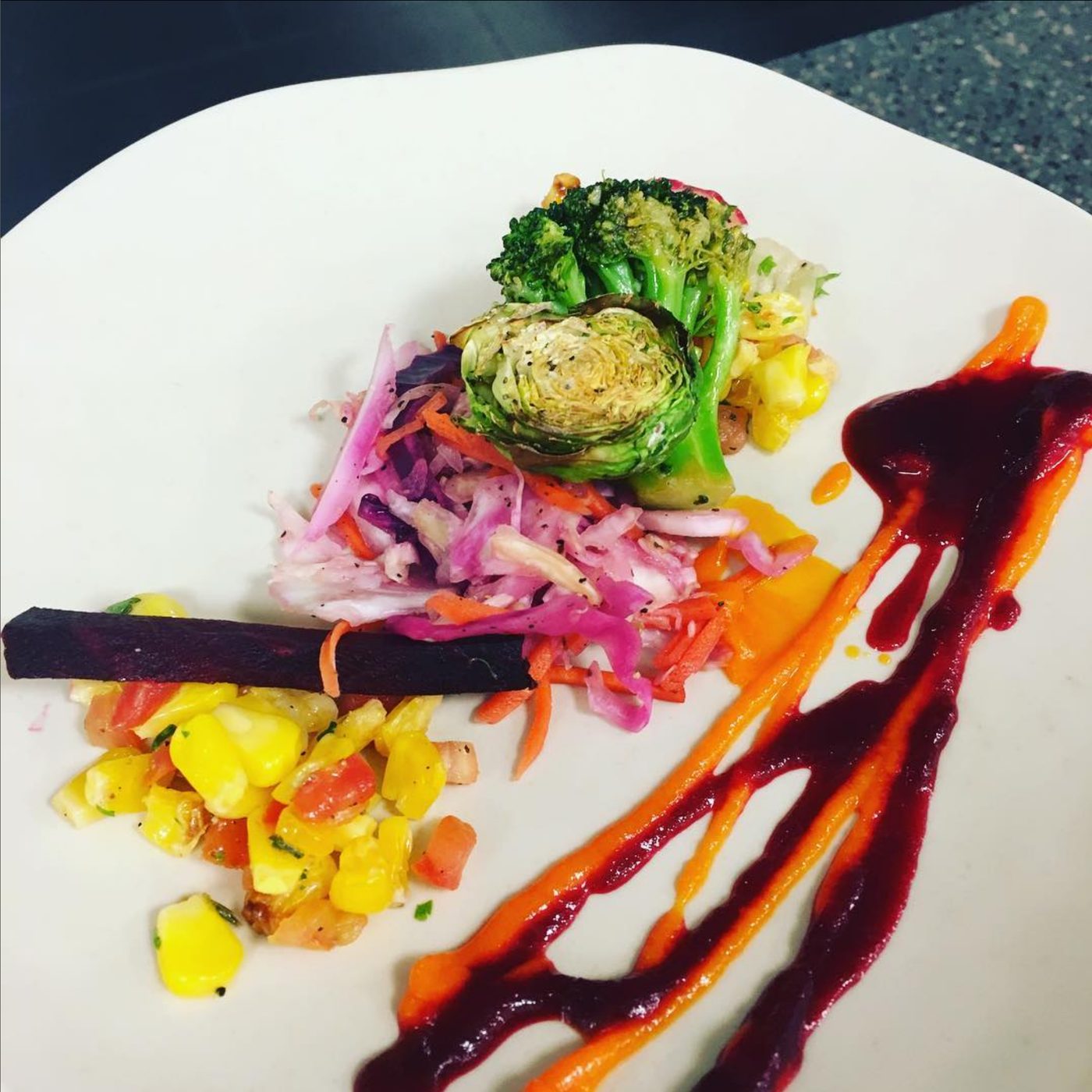 Roasted brussels sprouts and broccoli with slaw, corn salsa and beet purée